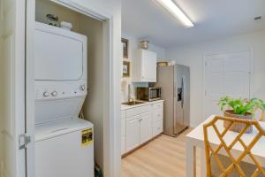a kitchen with white cabinets and a refrigerator at Idyllic Cave Spring Studio with Patio and Fire Pit! in Cave Spring