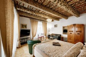 a bedroom with a bed and a living room at At the Blue Lion & Parking Assistance in Prague