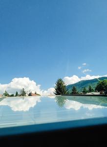 a reflection of the sky in a pool of water at Hostel Center Luxury in Sarajevo