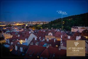 a view of a town at night with a sign at Hotel At the Green Grape in Prague