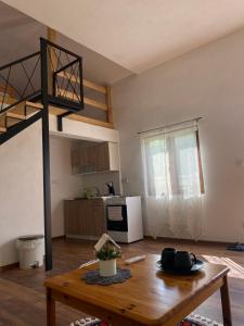 a living room with a table and a loft bed at Hill House Emir in Bihać