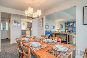 a dining room with a wooden table and chairs at Sandpiper Retreat in Waldport