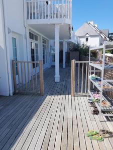 a porch of a house with a deck with surfboards at Résidence cap océan, Port du Crouesty in Arzon