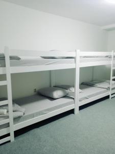 two white bunk beds in a room at Hostel Center Luxury in Sarajevo