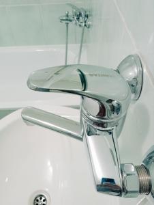 a close up of a bathroom sink with a faucet at Hostel Center Luxury in Sarajevo