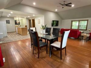 a dining room and living room with a table and chairs at ENTIRE 2-BEDROOM TOWNHOUSE ON a RUSTIC FARM - C in Arkona