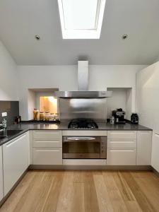a kitchen with white cabinets and a stove top oven at La Perla di Boccadasse in Genoa