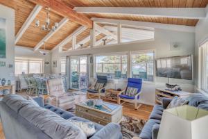 a living room with a blue couch and chairs at Captains Quarters in Lincoln City