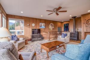 a living room with wooden walls and a ceiling fan at The Viking (MCA 410) in Manzanita