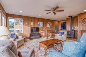 a living room with wooden walls and a ceiling fan at The Viking MCA 410 - Meredith Lodging in Manzanita