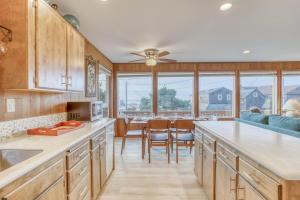 a kitchen with wooden cabinets and a dining room at The Viking MCA 410 - Meredith Lodging in Manzanita +30 photos