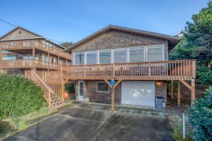 a large house with a deck and a garage at The Viking (MCA 410) in Manzanita