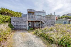 een oud huis met een terras op een onverharde weg bij 1058 Beach (MCA 59) in Manzanita