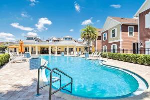 a swimming pool in front of a house at New Awesome decorated dreamhouse in Orlando