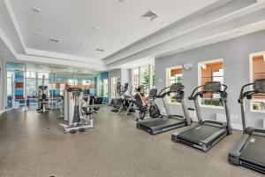 a gym with treadmills and elliptical machines at New Awesome decorated dreamhouse in Orlando