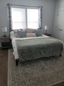 a bed in a bedroom with two lamps and a window at The Alamo Riverwalk Pearl Modern 4 Bedroom Home in San Antonio