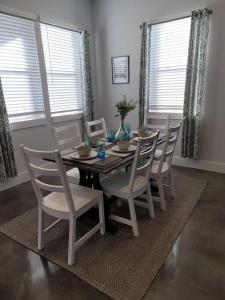 a dining room with a table and chairs at The Alamo Riverwalk Pearl Modern 4 Bedroom Home in San Antonio