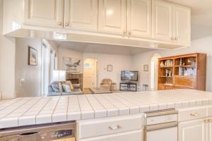 a kitchen with white cabinets and a counter top at Sea-Renity in Lincoln City