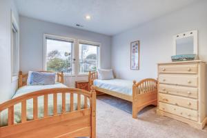 a bedroom with two twin beds and a dresser at Sea-Renity in Lincoln City