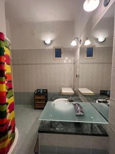 a bathroom with a sink and a large mirror at Elena Suite in Budapest