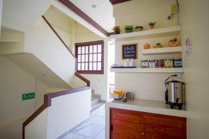 a kitchen with a stairway and a kitchen with a counter at Hotel Diamante in Santa Cruz Huatulco