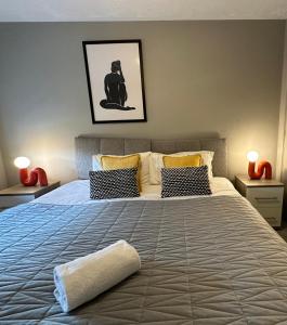 a bedroom with a large bed with a cat on it at Orchard House - Great Design, Comfortable furnitures, Free Wifi & Free Parking, Nice tidy Garden in Swindon
