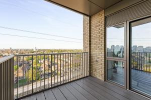 a balcony with a view of a city at Docklands Two Bed Apartment in London