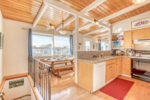 a kitchen with wooden ceilings and a dining room with a table at A Sea Breeze in Lincoln City