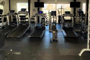 a gym with several tread machines in a room at Apartamento en Cabo San Lucas México in Cabo San Lucas