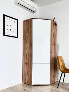 a wooden partition in a room with a chair at George Studio przy Stadionie Narodowym in Warsaw