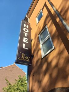 a sign for a restaurant on the side of a building at Cafe Hotel centrum in Bruchsal