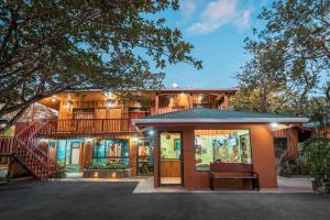 a house with a balcony and a staircase in front of it at Monteverde Villa Lodge in Monteverde Costa Rica