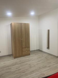 a wooden cabinet in a room with a wooden floor at Loft Home Sweet Home in Catania