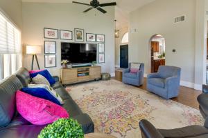 a living room with a couch and a tv at Spacious Gilbert Vacation Rental Near Water Ranch! in Gilbert