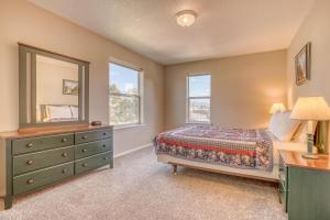 a bedroom with a bed and a dresser and a mirror at Seaside Vacation Rental in Seaside