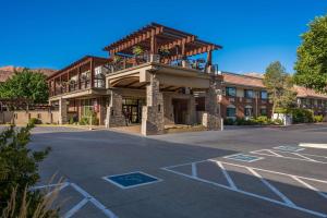 a building with a balcony on a parking lot at Best Western Plus Canyonlands Inn in Moab