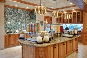 a kitchen with wooden cabinets and a counter with glasses at Homewood Suites by Hilton Boise in Boise