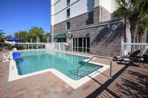 a swimming pool in front of a building at Hampton Inn Jacksonville - East Regency Square in Jacksonville