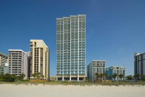 a group of tall buildings in front of a beach at Hilton Grand Vacations Club Ocean 22 Myrtle Beach in Myrtle Beach
