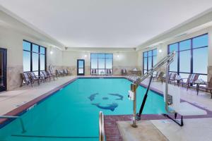 a swimming pool with blue water in a building at Hampton Inn & Suites Oklahoma City - South in Oklahoma City