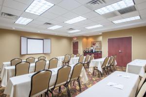 a conference room with tables and chairs and a screen at Hampton Inn & Suites Oklahoma City - South in Oklahoma City +36 photos