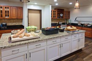 a kitchen with a counter with bread and vegetables on it at Homewood Suites by Hilton Fairfield-Napa Valley Area in Cordelia Junction