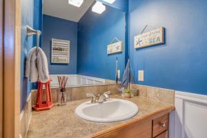 a bathroom with a sink and a mirror at Pelicans Perch Pacific City - Meredith Lodging in Pacific City +52 photos