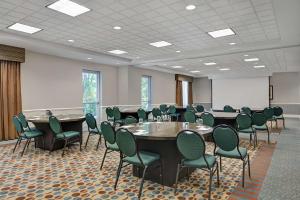 a conference room with tables and chairs and a whiteboard at Hilton Garden Inn Jacksonville JTB/Deerwood Park in Jacksonville +38 photos