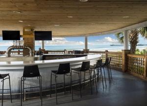 a bar with chairs and a view of the ocean at Royale Palms Condominiums in Myrtle Beach