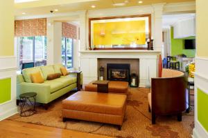 a living room with a couch and a fireplace at Hilton Garden Inn Savannah Midtown in Savannah