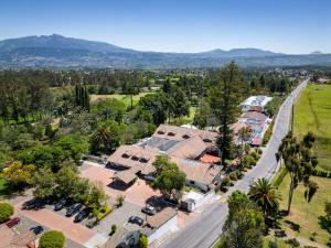 an aerial view of a house with trees and a road at San Jose De Puembo Quito Airport, An Ascend Hotel Collection in Puembo