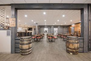 a large room with tables and chairs and a kitchen at Clarion Hotel & Convention Center Joliet in Joliet