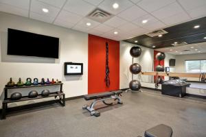 a room with a gym with a flat screen tv at Tru By Hilton Chicopee Springfield in Chicopee