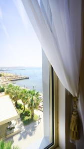 an open window with a view of the beach at Sea view apartement in Durrës